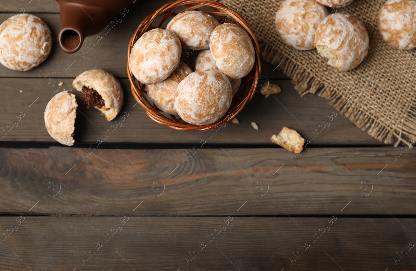 Photo of Tasty homemade gingerbread cookies on wooden table, flat lay. Space for text