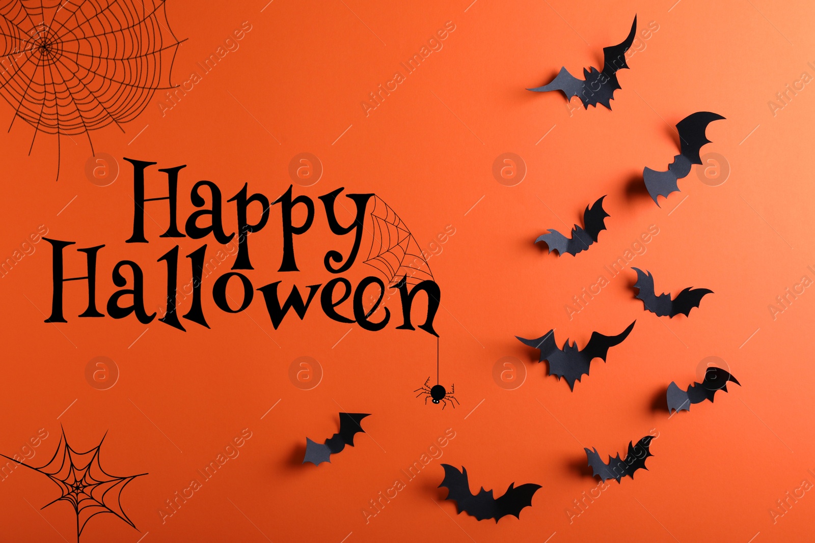 Image of Happy Halloween. Paper bats on orange background, flat lay