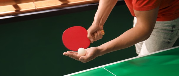Man playing ping pong indoors, closeup view. Banner design