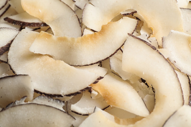 Delicious fresh coconut chips as background, closeup