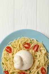 Plate of delicious pasta with burrata and tomatoes on white wooden table, top view. Space for text