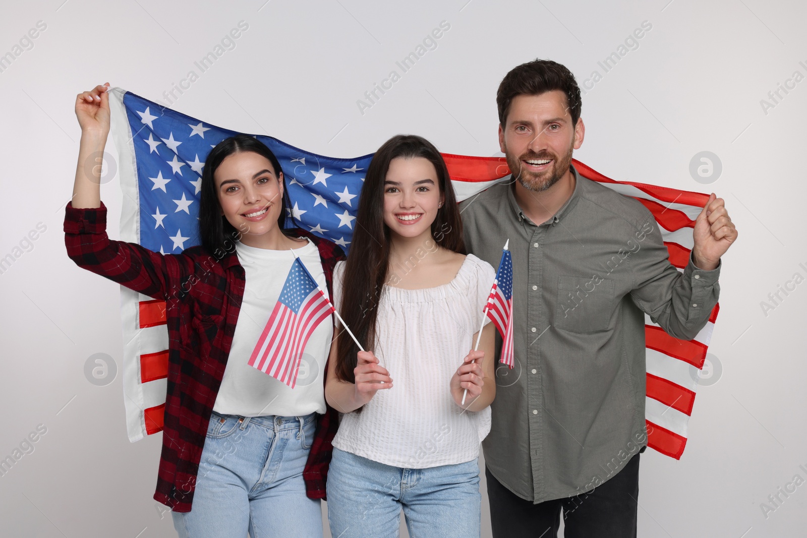 Photo of 4th of July - Independence Day of USA. Happy family with American flags on white background