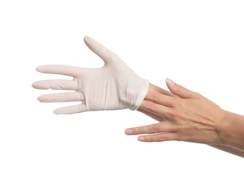 Doctor taking off medical gloves on white background, closeup