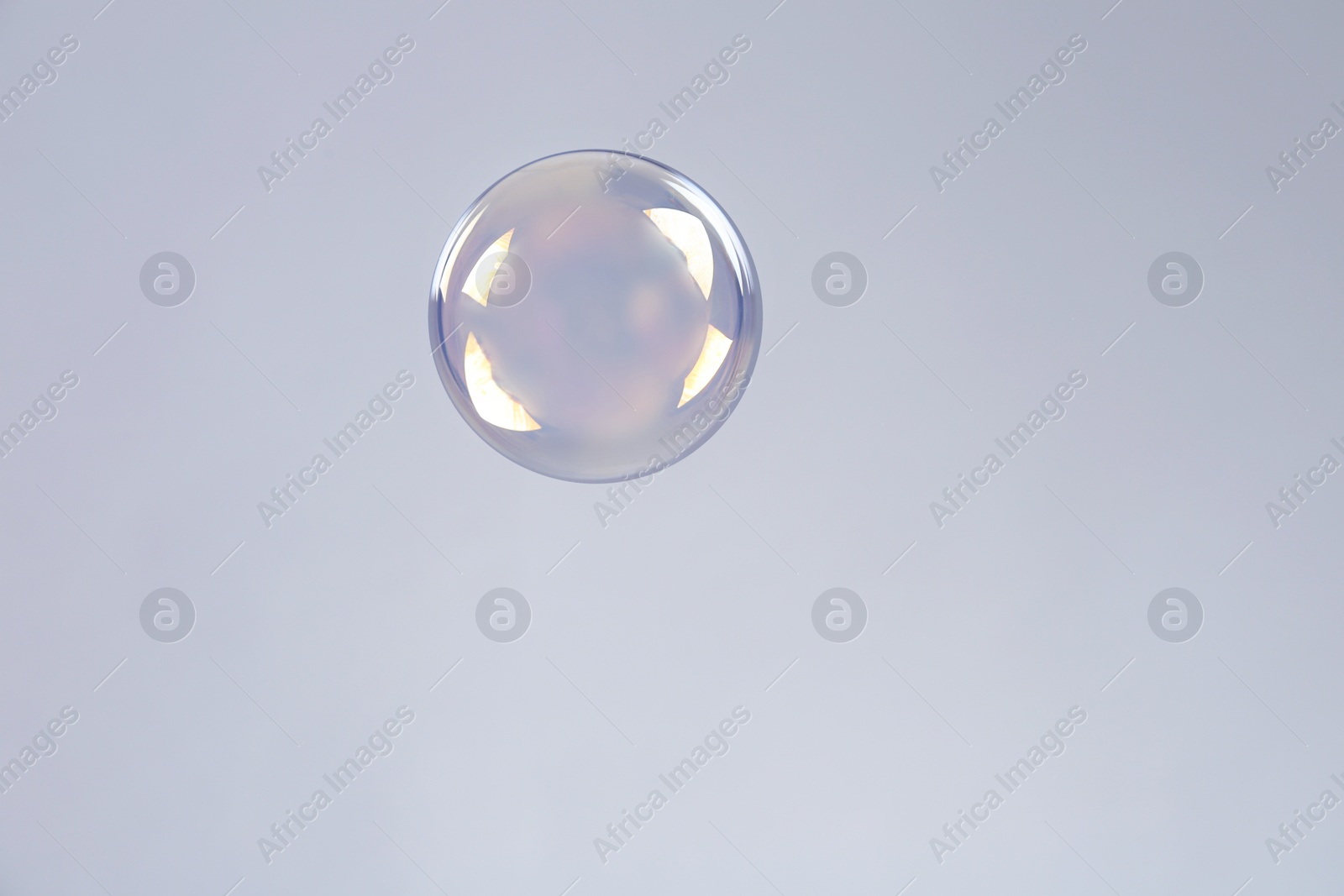 Photo of Beautiful translucent soap bubble on grey background