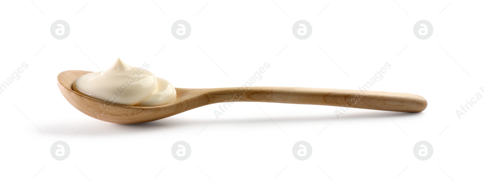 Photo of Natural yogurt in wooden spoon isolated on white