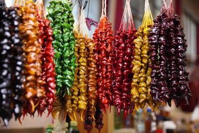 Photo of Bunches of different delicious churchkhelas at market