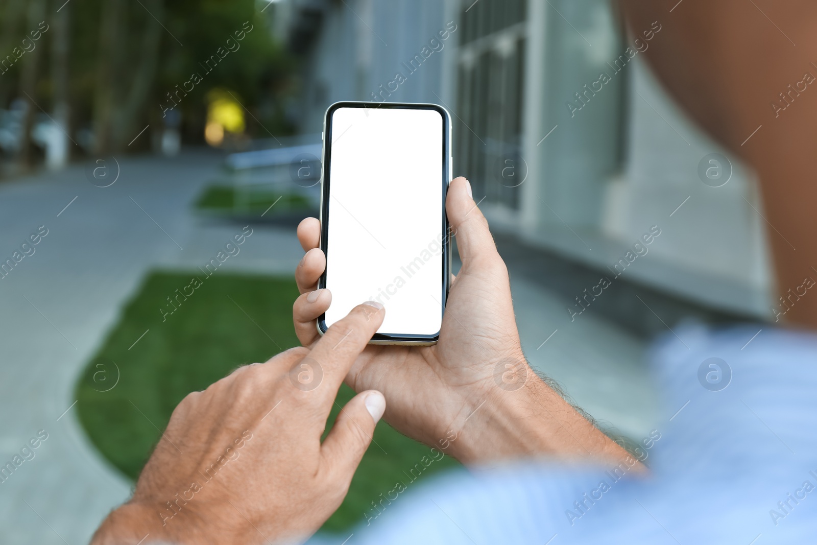 Photo of Man using modern mobile phone outdoors, closeup
