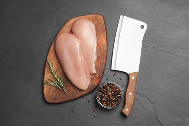 Flat lay composition with fresh chicken meat on black table