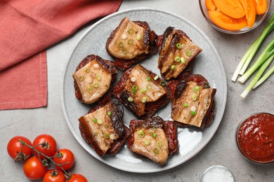 Tasty sandwiches with fried pork fatback slices on grey table, flat lay