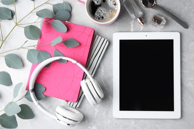 Flat lay composition with tablet on grey background, space for text. Blogger's workplace