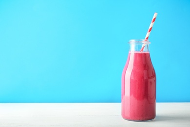 Bottle with delicious detox smoothie on table