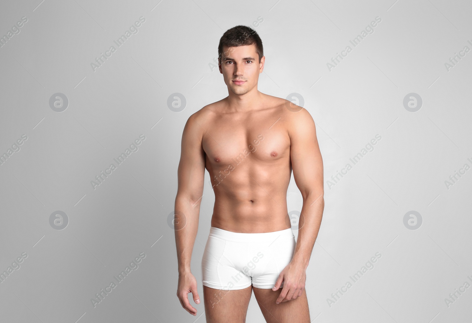 Photo of Man with sexy body on light background