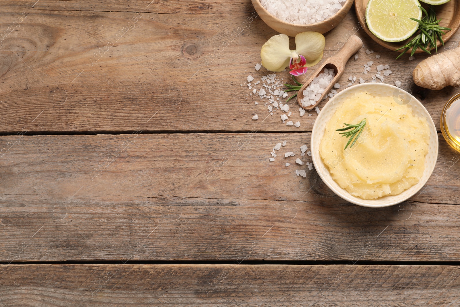 Photo of Flat lay composition with body scrub on wooden table, space for text