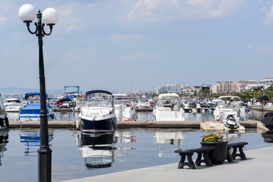 Beautiful view of city pier with moored boats on sunny day