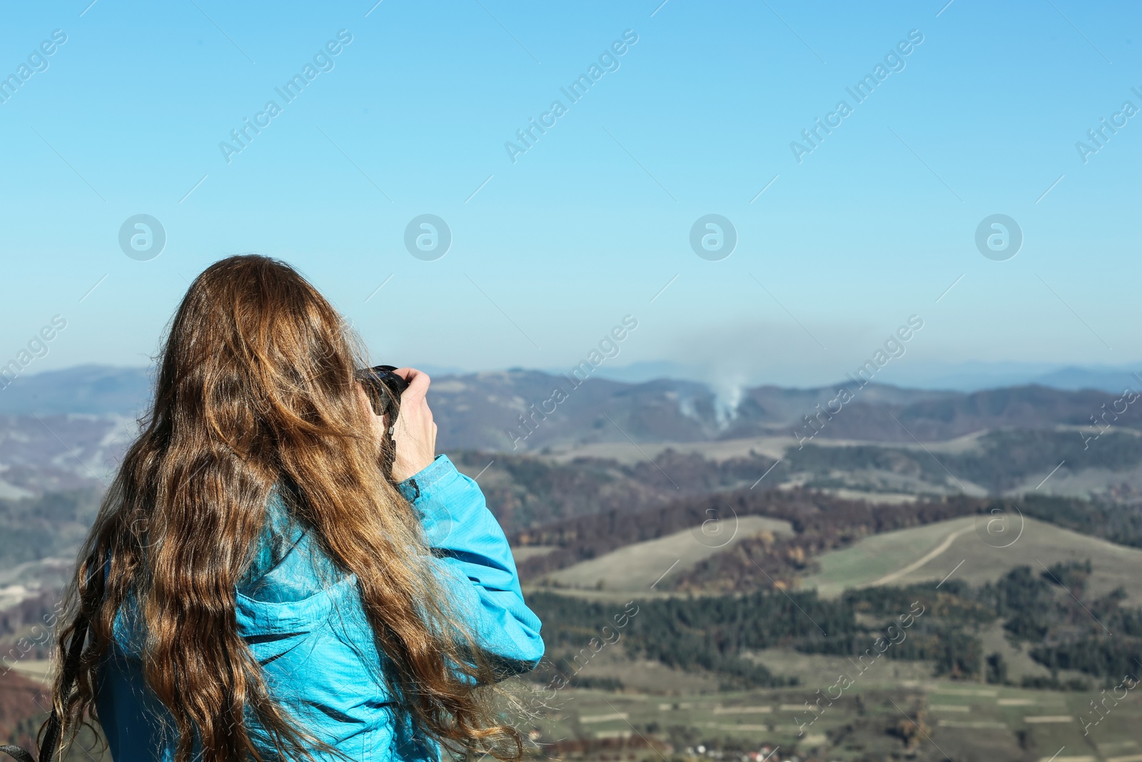 Photo of Professional nature photographer taking photo of mountain landscape