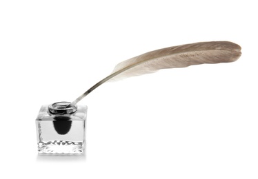 Photo of Feather pen and inkwell on white background