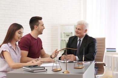 Lawyer having meeting with young couple in office