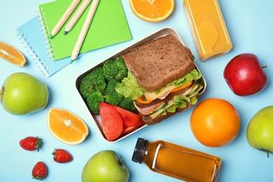 Photo of Flat lay composition with healthy food for school child on color background