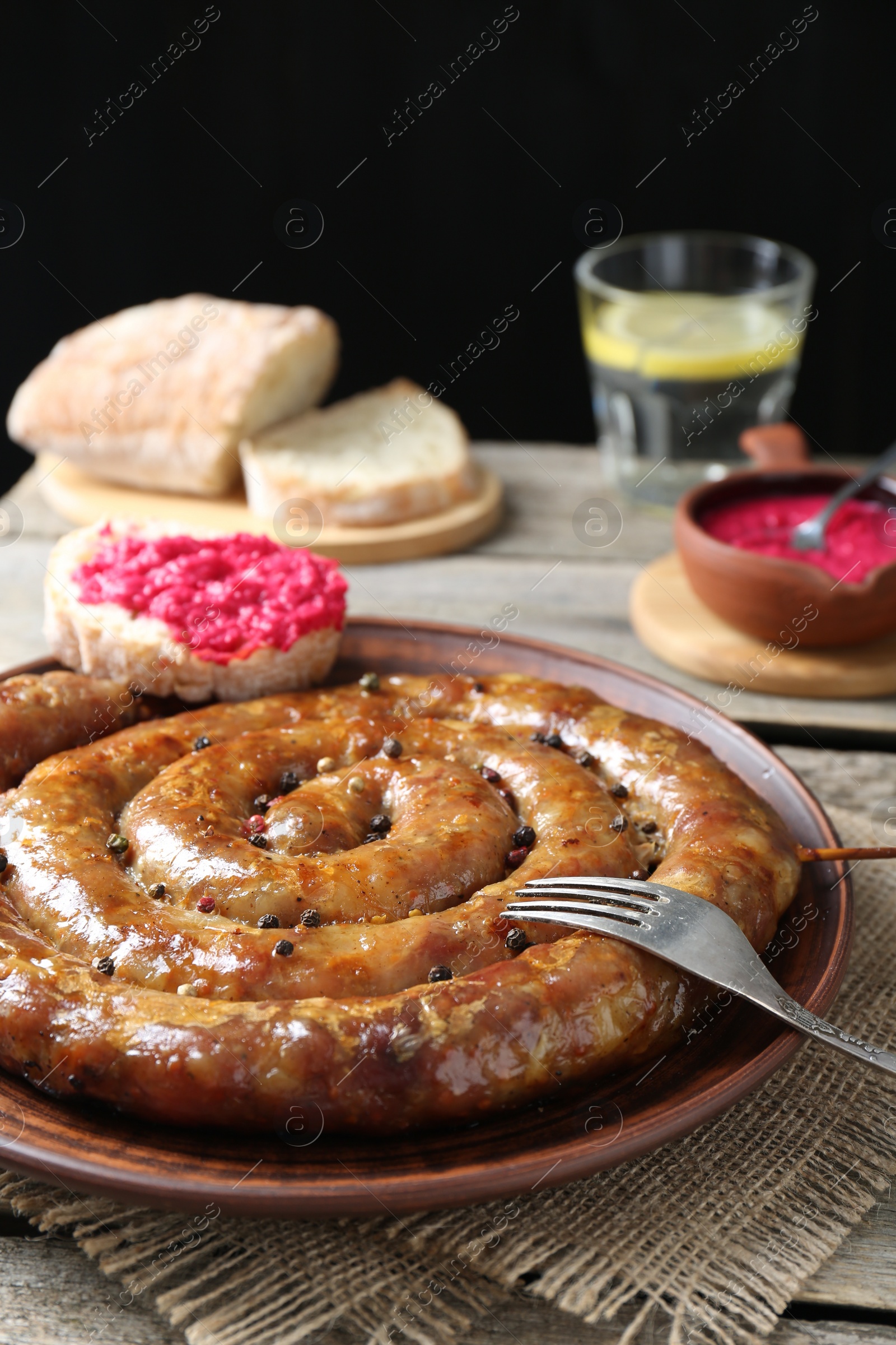 Photo of Tasty homemade sausages served on wooden table