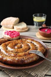 Tasty homemade sausages served on wooden table