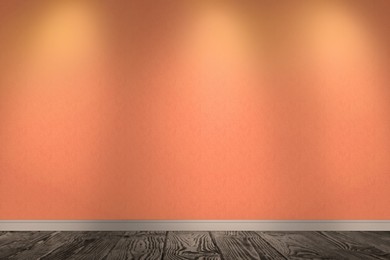 Orange wallpaper and wooden floor in room