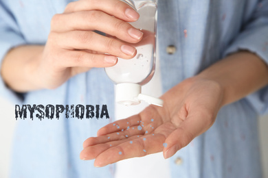 Image of Woman applying antiseptic gel on hand, closeup. Mysophobia