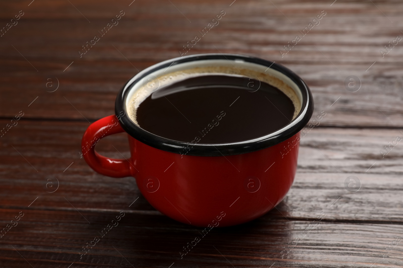 Photo of Cup of aromatic coffee on wooden table, closeup