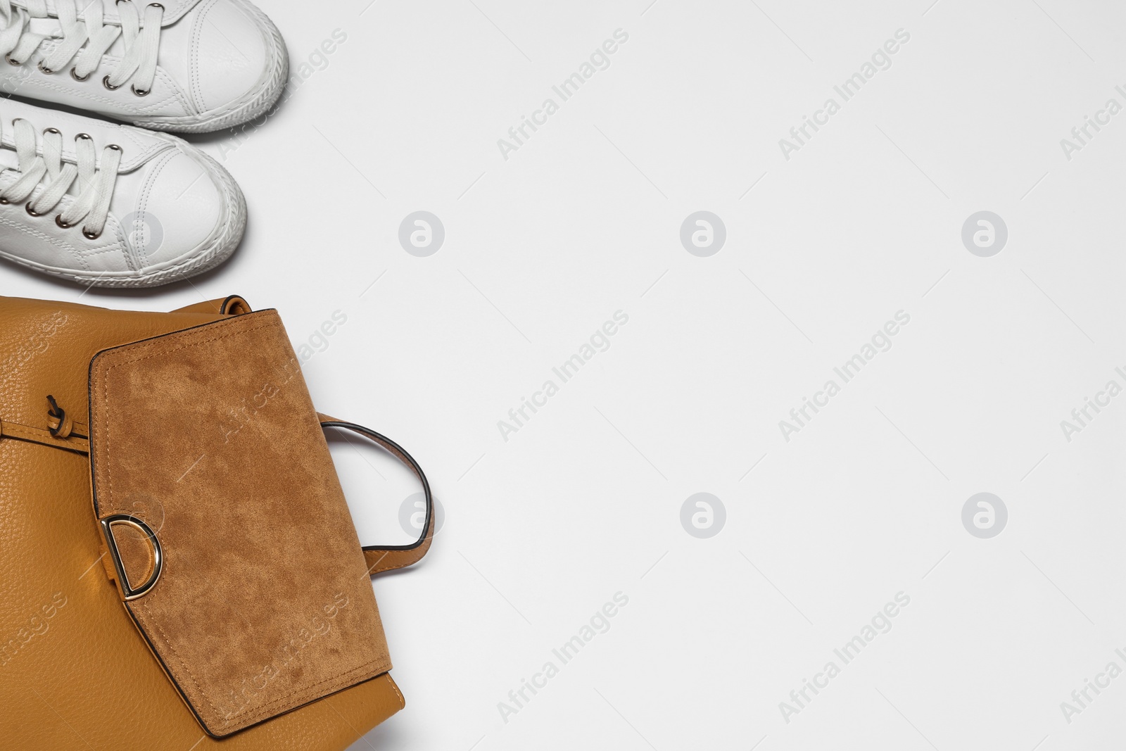 Photo of Stylish casual backpack and sneakers on white background, top view