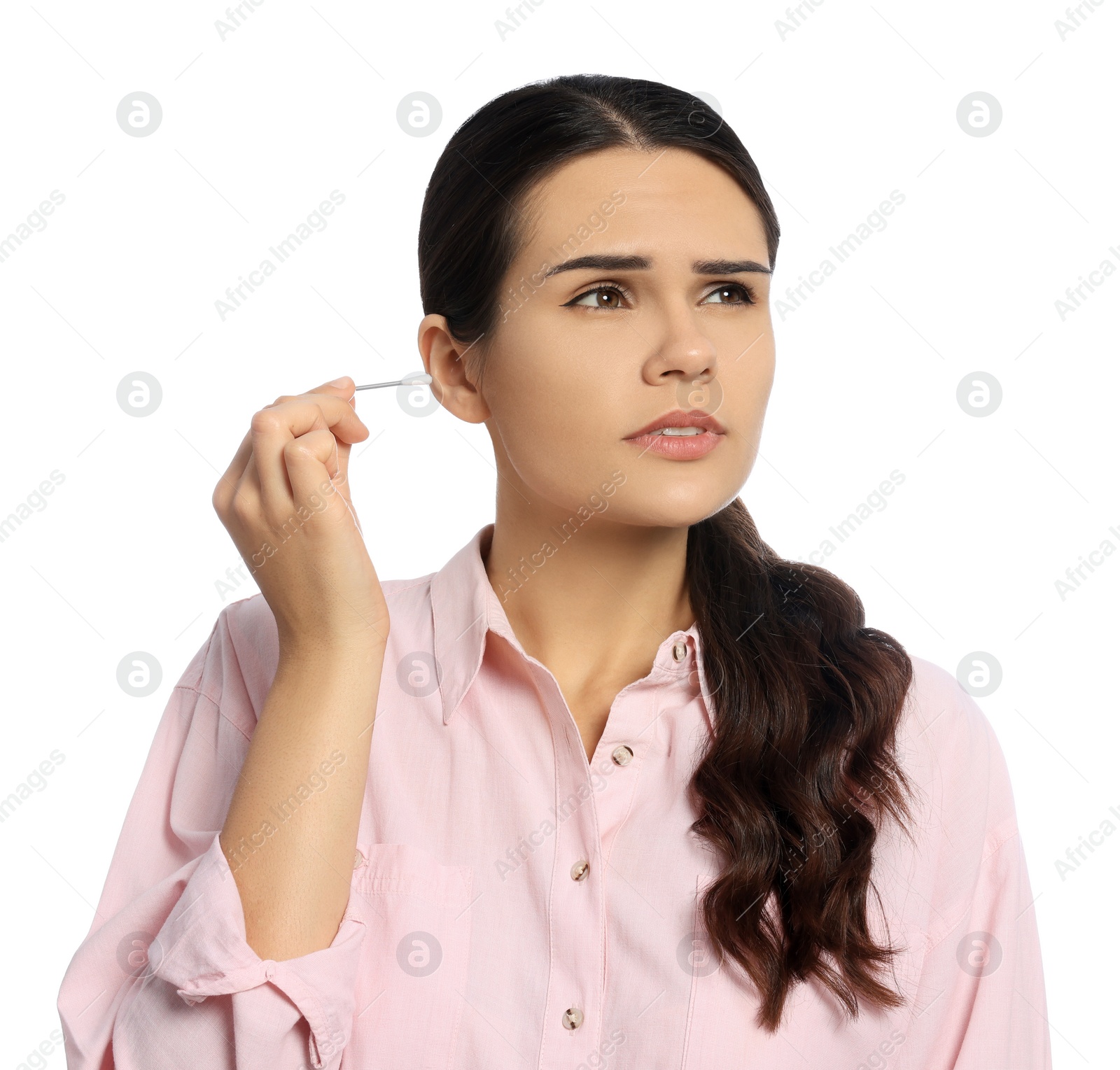 Photo of Young woman cleaning ear with cotton swab on white background