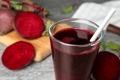 Photo of Freshly made beet juice on table, closeup