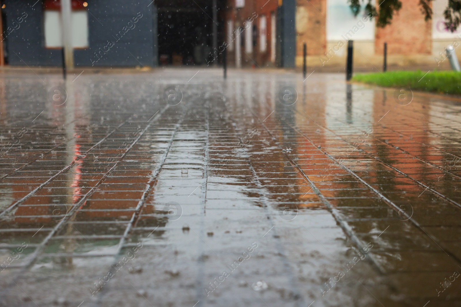 Photo of View of city street with puddles on rainy day, closeup