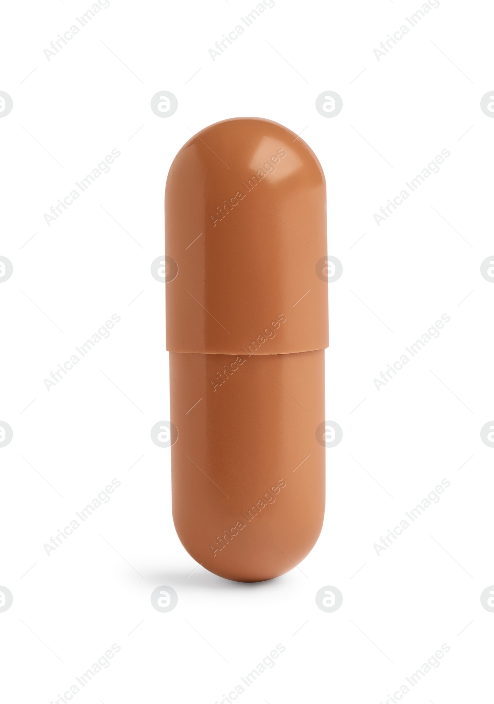 Photo of One brown pill on white background. Medicinal treatment