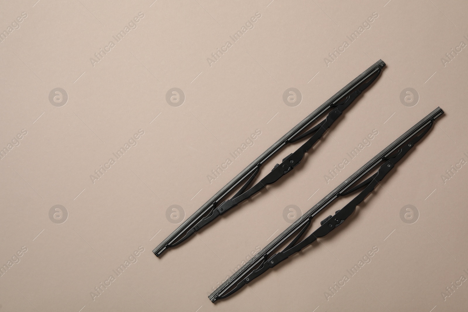 Photo of Car windshield wipers on beige background, flat lay. Space for text