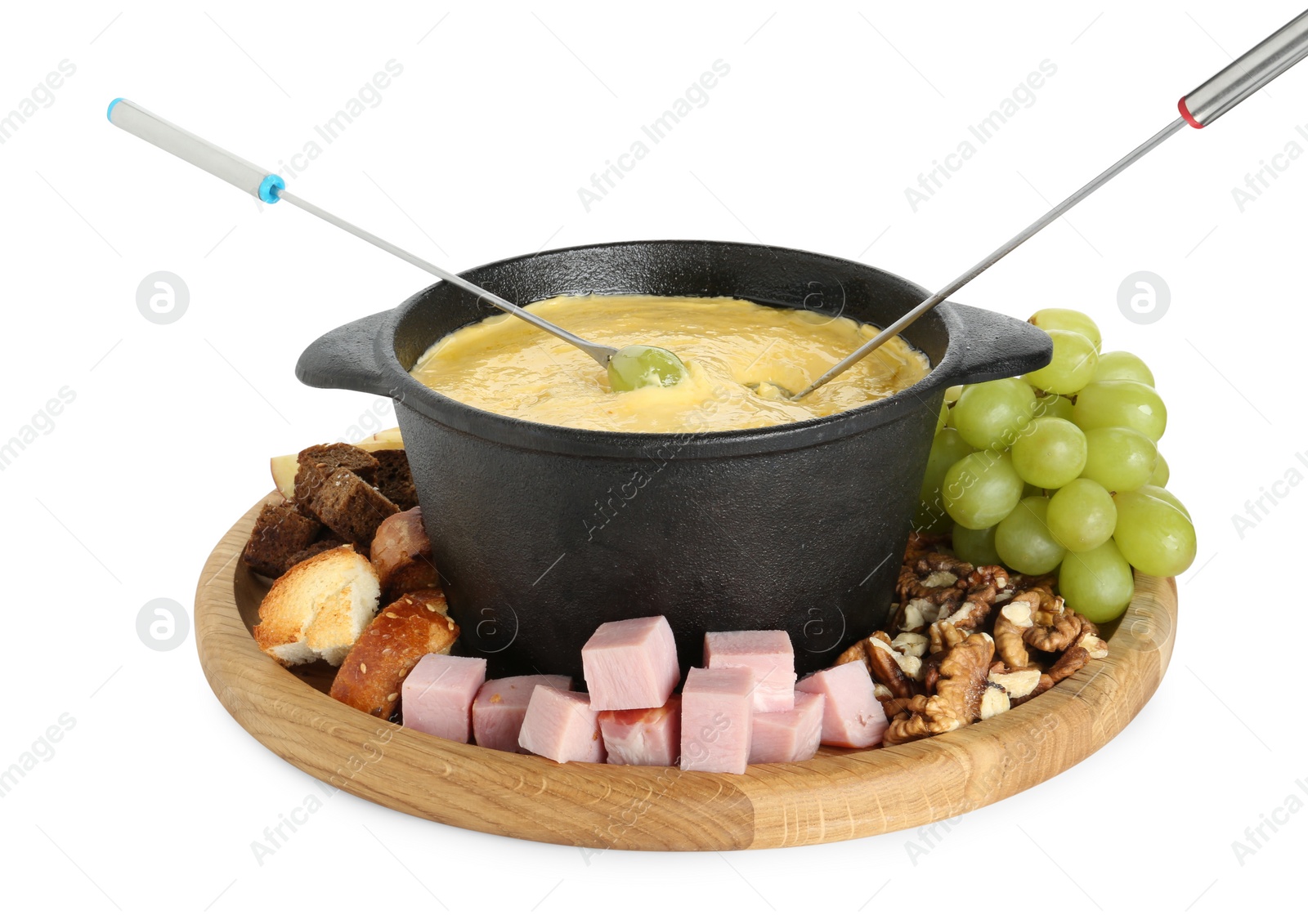 Photo of Fondue with tasty melted cheese, forks and different products isolated on white