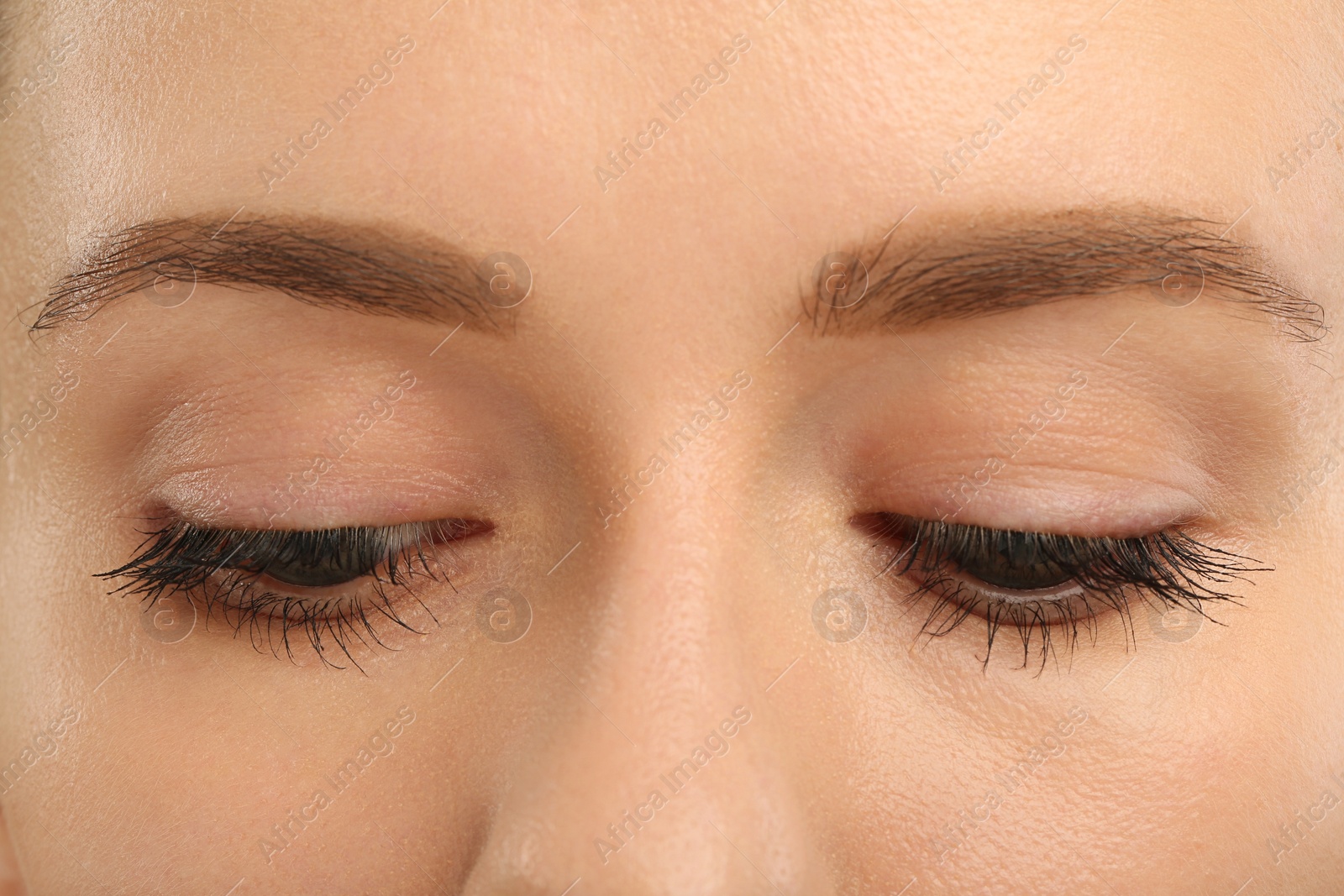 Photo of Woman with long eyelashes after mascara applying, closeup