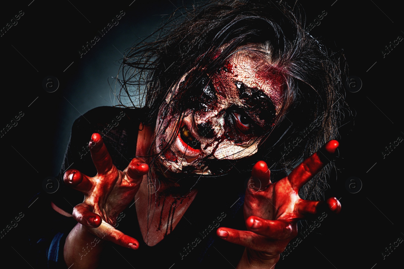 Photo of Scary zombie on dark background. Halloween monster