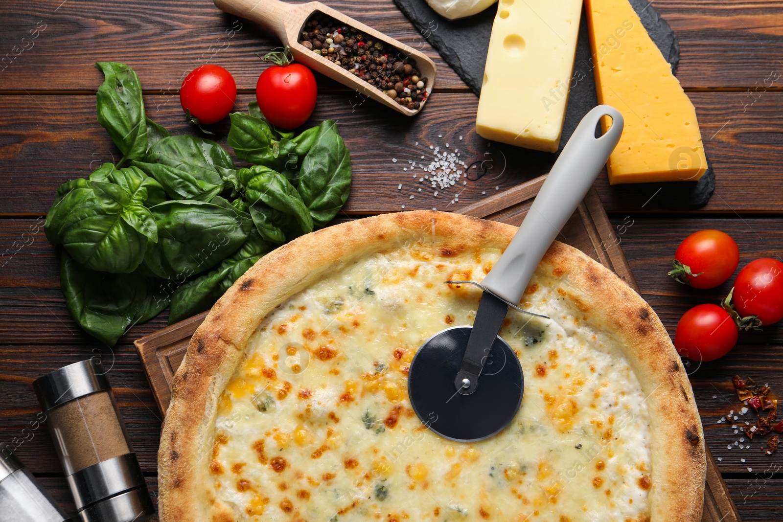 Photo of Flat lay composition with delicious cheese pizza and ingredients on wooden table