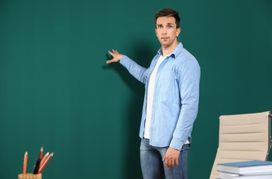 Portrait of male teacher in classroom. Space for text