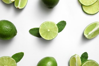 Photo of Flat lay composition with fresh juicy limes and mint on white background