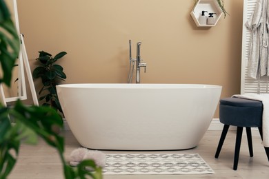 Cozy bathroom interior with stylish ceramic tub