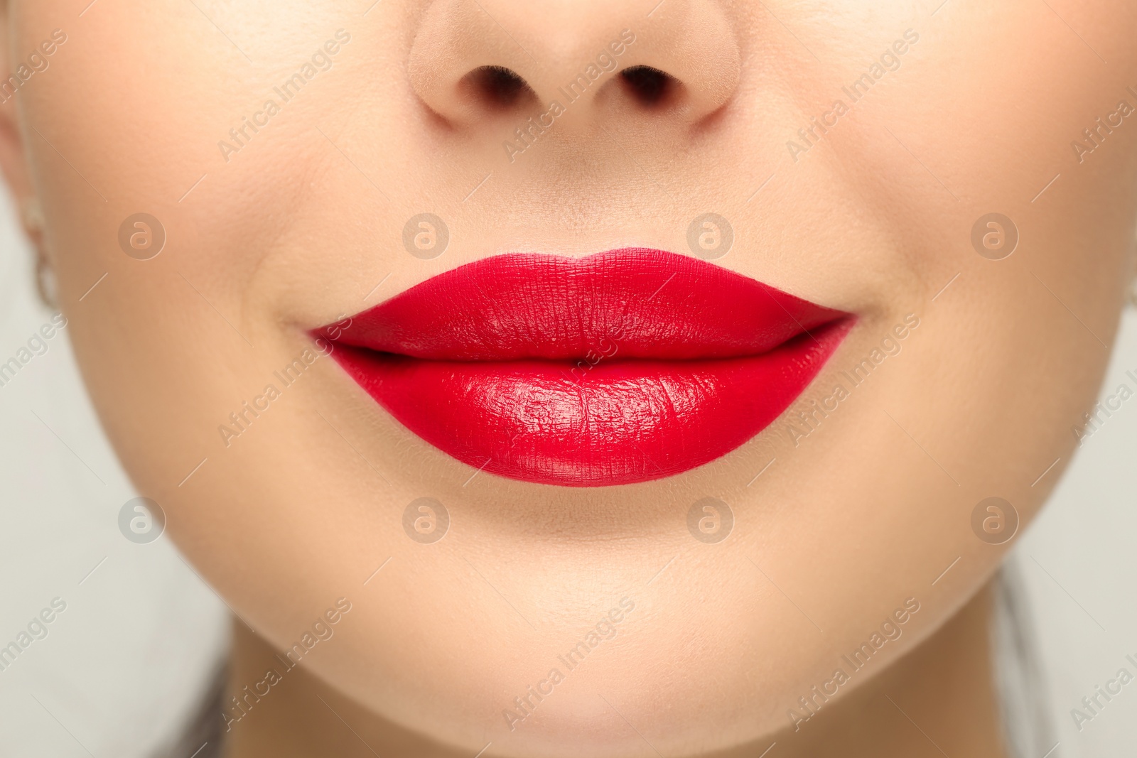 Photo of Woman with red lipstick on light background, closeup