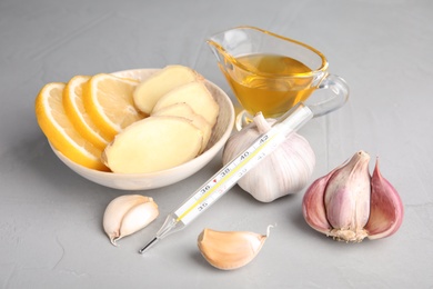 Composition with garlic and other cold remedies on grey table