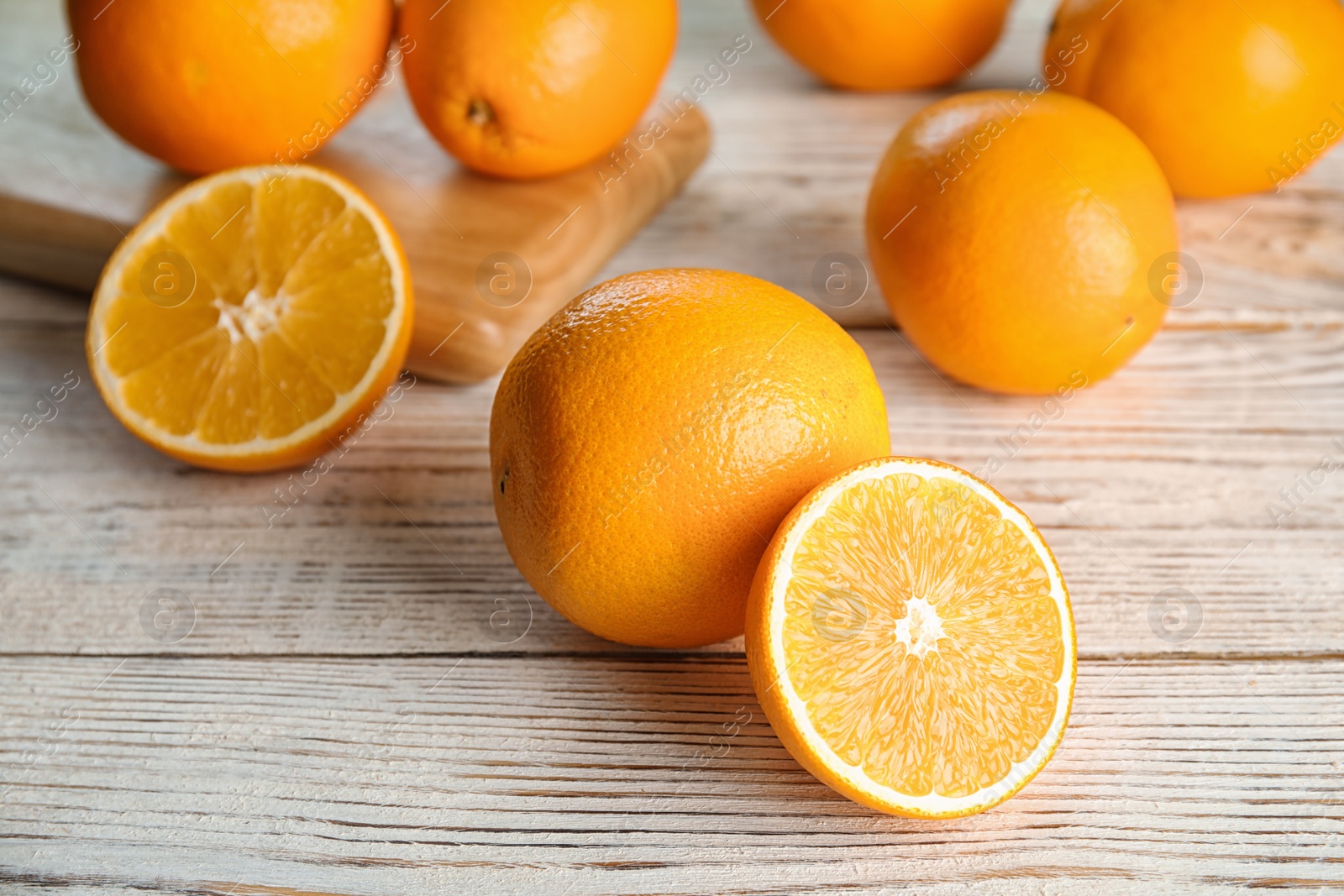 Photo of Fresh juicy oranges on wooden table. Healthy fruits