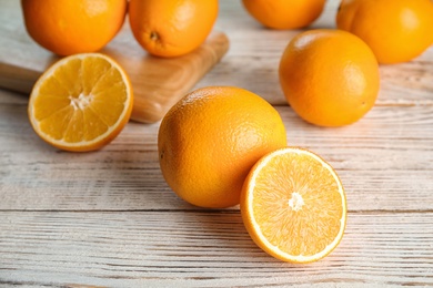 Fresh juicy oranges on wooden table. Healthy fruits