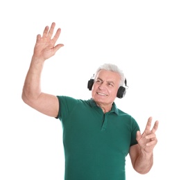 Mature man enjoying music in headphones on white background