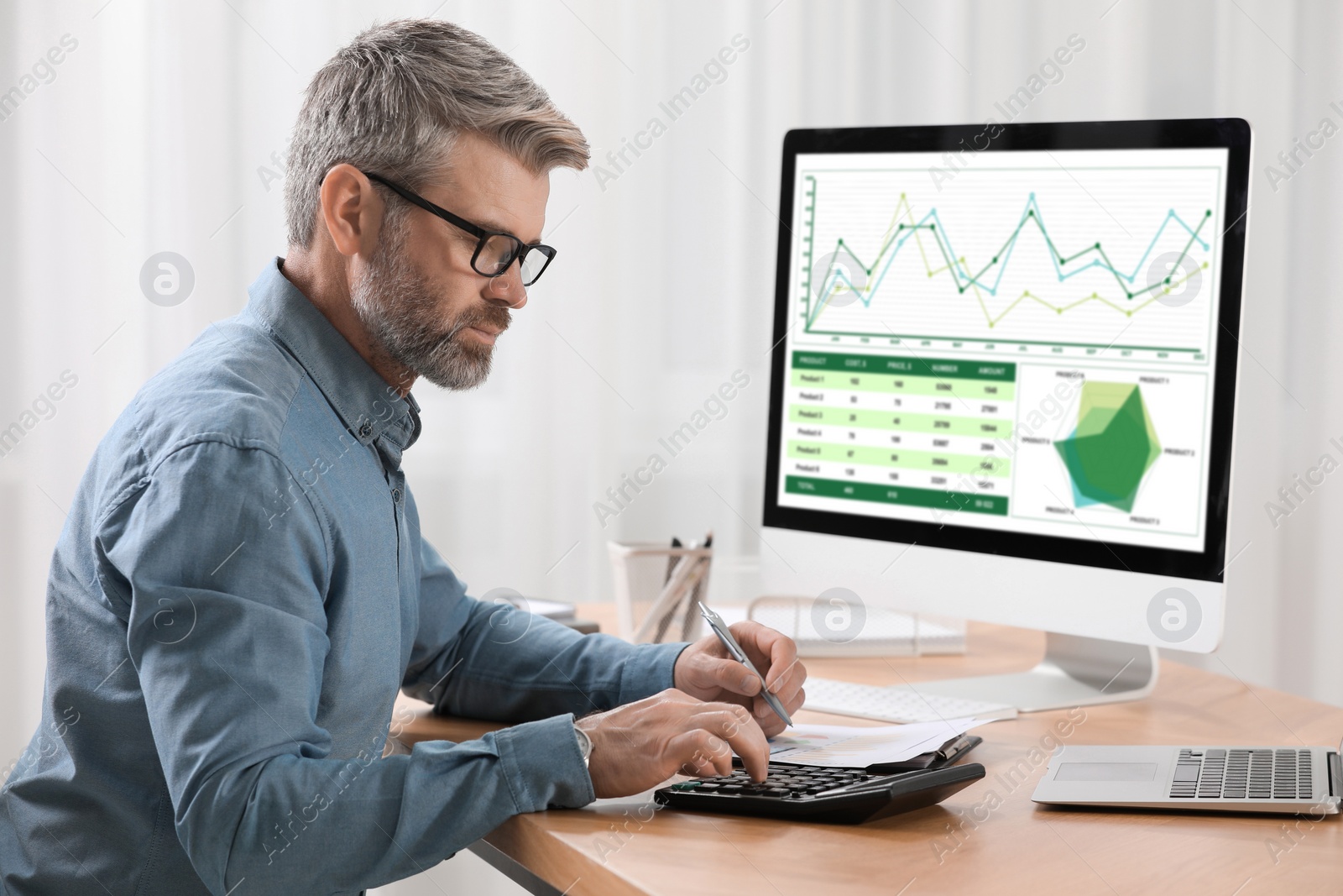 Photo of Professional accountant working at wooden desk in office