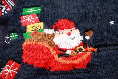 Photo of Cute Christmas sweater as background, closeup view