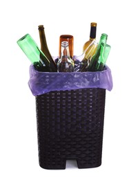 Photo of Trash bin full of glass bottles on white background. Recycling rubbish