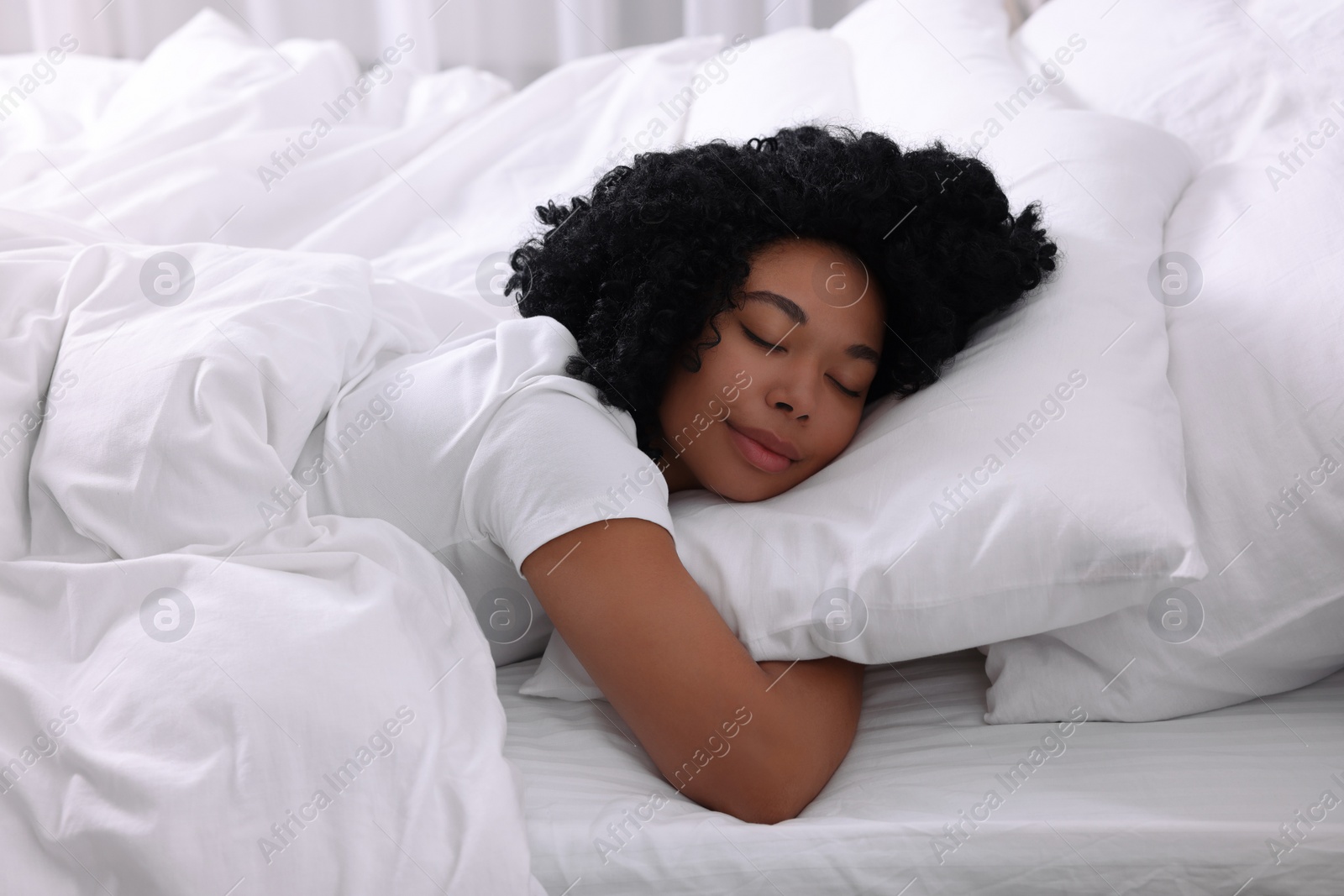 Photo of Beautiful young woman sleeping in soft bed