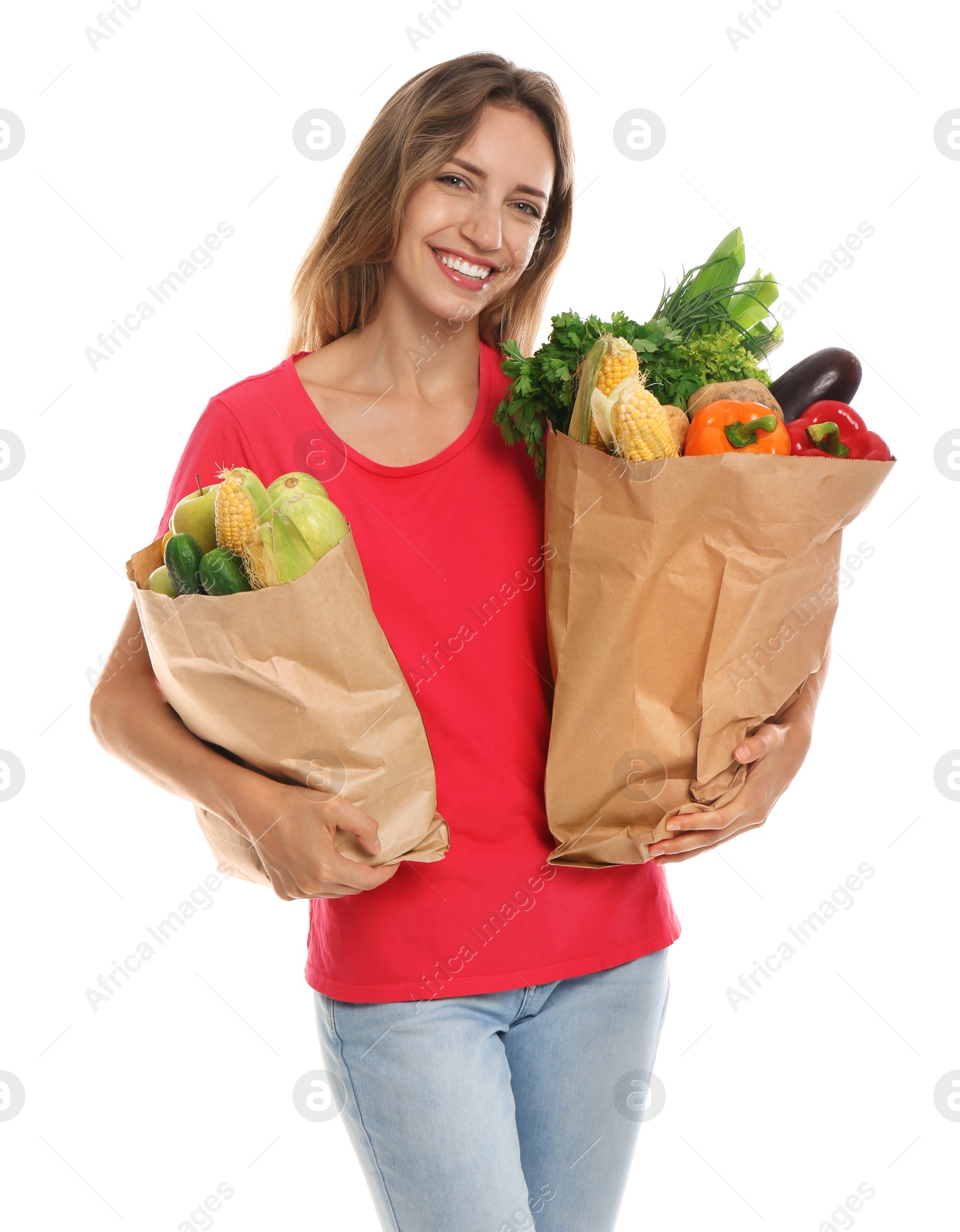 Photo of Young woman with bags of fresh vegetables isolated on white